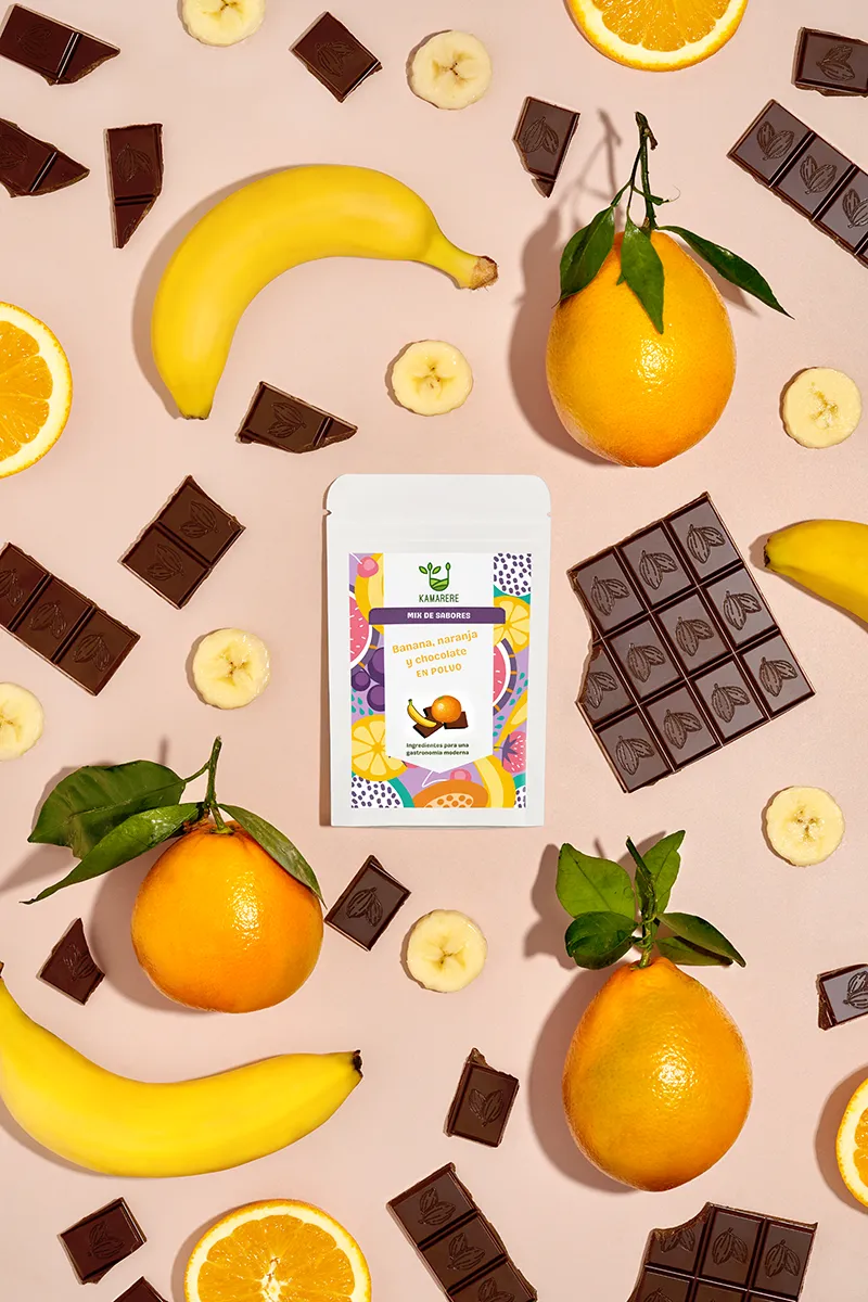 A commercial photograph of Kamarere’s 100% natural dehydrated fruit and vegetable powder in a resealable white pouch. The colorful label features a modern, vibrant fruit and vegetable pattern with the Kamarere logo at the top. The packaging highlights its preservative-free and additive-free composition, emphasizing its use for innovative cooking and gastronomy. The label includes an illustration representing fresh ingredients, reinforcing its natural origin.