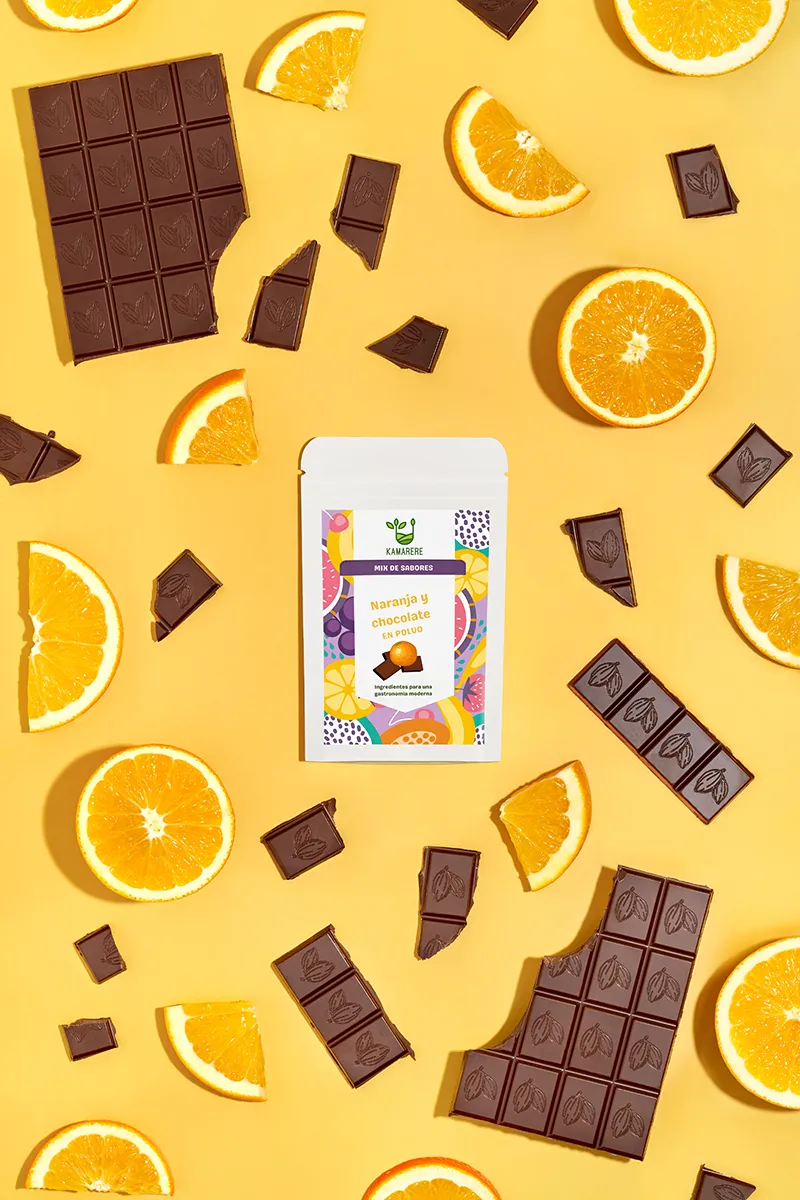A commercial photograph of Kamarere’s 100% natural dehydrated fruit and vegetable powder in a resealable white pouch. The colorful label features a modern, vibrant fruit and vegetable pattern with the Kamarere logo at the top. The packaging highlights its preservative-free and additive-free composition, emphasizing its use for innovative cooking and gastronomy. The label includes an illustration representing fresh ingredients, reinforcing its natural origin.