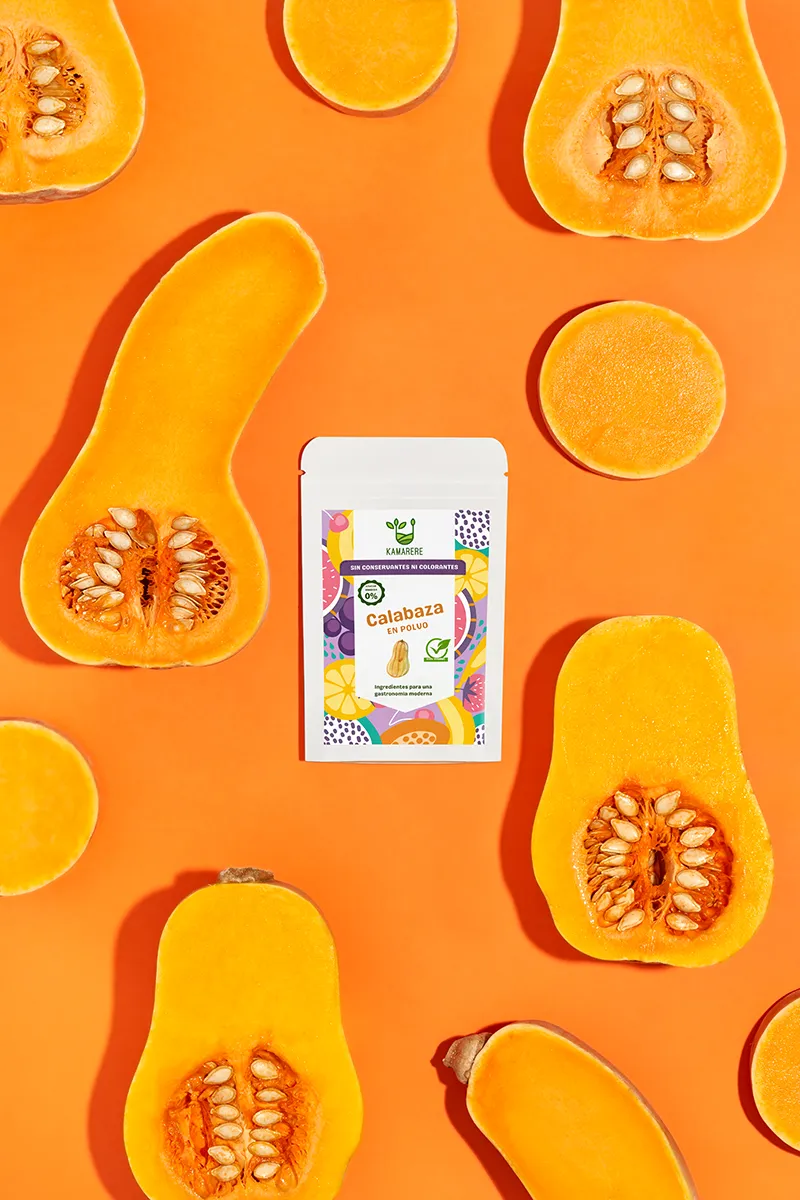 A commercial photograph of Kamarere’s 100% natural dehydrated fruit and vegetable powder in a resealable white pouch. The colorful label features a modern, vibrant fruit and vegetable pattern with the Kamarere logo at the top. The packaging highlights its preservative-free and additive-free composition, emphasizing its use for innovative cooking and gastronomy. The label includes an illustration representing fresh ingredients, reinforcing its natural origin.